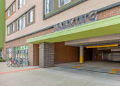 Thumbnail 10 of 42 - the parking garage entrance of a building with bikes parked outside