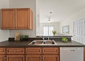 Thumbnail 34 of 67 - a kitchen with wooden cabinets and a sink