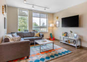 Thumbnail 35 of 42 - a living room with a couch and a tv