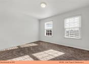 Thumbnail 27 of 35 - A room with a carpeted floor and two windows.