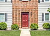 Thumbnail 3 of 17 - a red door on a white house