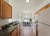 Thumbnail 35 of 67 - a kitchen with wooden cabinets and a white refrigerator