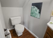 Thumbnail 23 of 48 - a bathroom with a toilet sink and a painting on the wall
