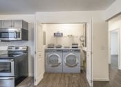 Thumbnail 28 of 43 - a laundry room with a washer and dryer