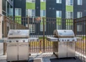 Thumbnail 1 of 42 - two stainless steel bbq grills in front of an apartment building