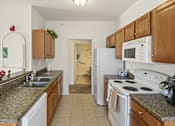 Thumbnail 44 of 67 - a kitchen with granite counter tops and white appliances