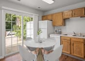 Thumbnail 13 of 48 - a kitchen with wood cabinets and a white marble table with four white chairs