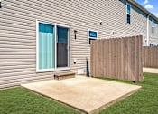 Thumbnail 6 of 17 - a patio in front of a house with a wooden fence
