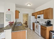 Thumbnail 48 of 67 - a kitchen with white appliances and granite counter tops