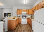 Thumbnail 38 of 48 - a kitchen with wood cabinets and white appliances