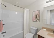 Thumbnail 60 of 67 - a bathroom with a shower and a sink and a toilet