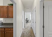 Thumbnail 47 of 67 - an empty kitchen with a hallway to a living room and a dining room
