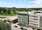 Thumbnail 1 of 56 - A view of a parking lot and two buildings from above.
