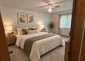 Thumbnail 11 of 13 - A bedroom with a large bed and two framed pictures on the wall.