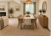 Thumbnail 8 of 13 - A dining room with a table set for six and a couch with a throw on it.
