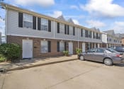 Thumbnail 6 of 48 - a row of apartment buildings with cars parked in front of them