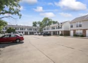 Thumbnail 7 of 48 - a parking lot in front of an apartment complex