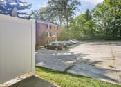 Thumbnail 8 of 48 - a white fence in front of a parking lot