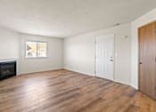 Thumbnail 40 of 64 - A room with a fireplace and wood flooring.