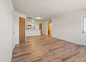 Thumbnail 13 of 64 - A room with wooden floors and white walls.
