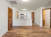 Thumbnail 33 of 64 - A kitchen with white appliances and wooden floors.