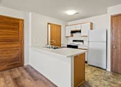 Thumbnail 27 of 64 - A kitchen with a white countertop and a white refrigerator.