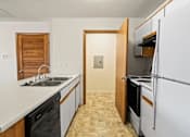 Thumbnail 24 of 64 - A kitchen with a sink, dishwasher, and refrigerator.