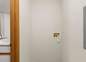 Thumbnail 36 of 64 - A white wall with a small picture frame and a grey electrical box.