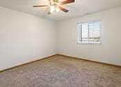 Thumbnail 17 of 64 - A room with a ceiling fan and a window with blinds.