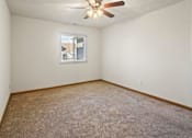 Thumbnail 21 of 64 - A room with a ceiling fan and a window with blinds.