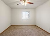Thumbnail 31 of 64 - A room with a ceiling fan and a window with blinds.