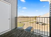 Thumbnail 18 of 64 - A balcony with a black railing and a white door.