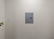 Thumbnail 38 of 64 - A grey metal safe is on a white wall.