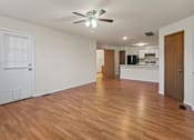 Thumbnail 19 of 64 - A room with wooden floors and a ceiling fan.