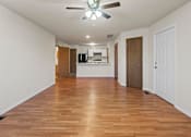 Thumbnail 61 of 64 - A room with wooden floors and a ceiling fan.