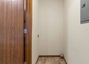 Thumbnail 47 of 64 - A room with a wooden door and a tiled floor.