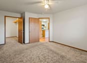 Thumbnail 52 of 64 - A room with a carpeted floor and a ceiling fan.