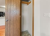 Thumbnail 49 of 64 - A wooden door is open to a room with a light switch on the wall.