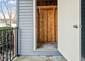 Thumbnail 44 of 64 - A doorway with a white door and a wooden wall in the background.