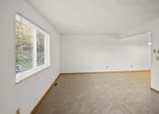 Thumbnail 17 of 26 - an empty room with a large window and carpet