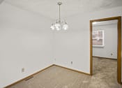 Thumbnail 24 of 26 - the living room and dining room of an empty house with a mirror