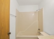 Thumbnail 25 of 26 - a bathroom with a shower and a sink and a toilet