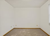 Thumbnail 22 of 26 - an empty room with a carpeted floor and a window