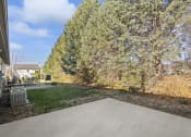 Thumbnail 5 of 15 - a driveway with trees and a house in the background
