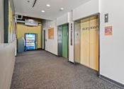 Thumbnail 24 of 56 - A hallway with a sign that says Storyboard at the top of the stairs.