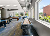 Thumbnail 21 of 56 - A room with a pool table and a foosball table.