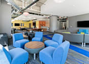 Thumbnail 13 of 56 - A conference room with blue chairs and a wooden table.