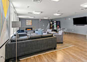 Thumbnail 15 of 56 - A modern living room with a grey sofa and a wooden floor.