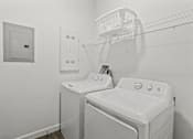 Thumbnail 35 of 38 - A white washing machine and dryer in a laundry room.