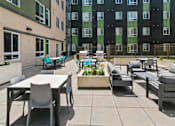 Thumbnail 11 of 56 - A patio with a table and chairs is surrounded by a fence.
